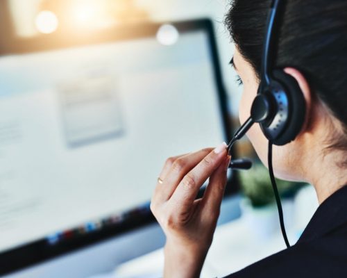 Rearview shot of a young woman working in a call centre